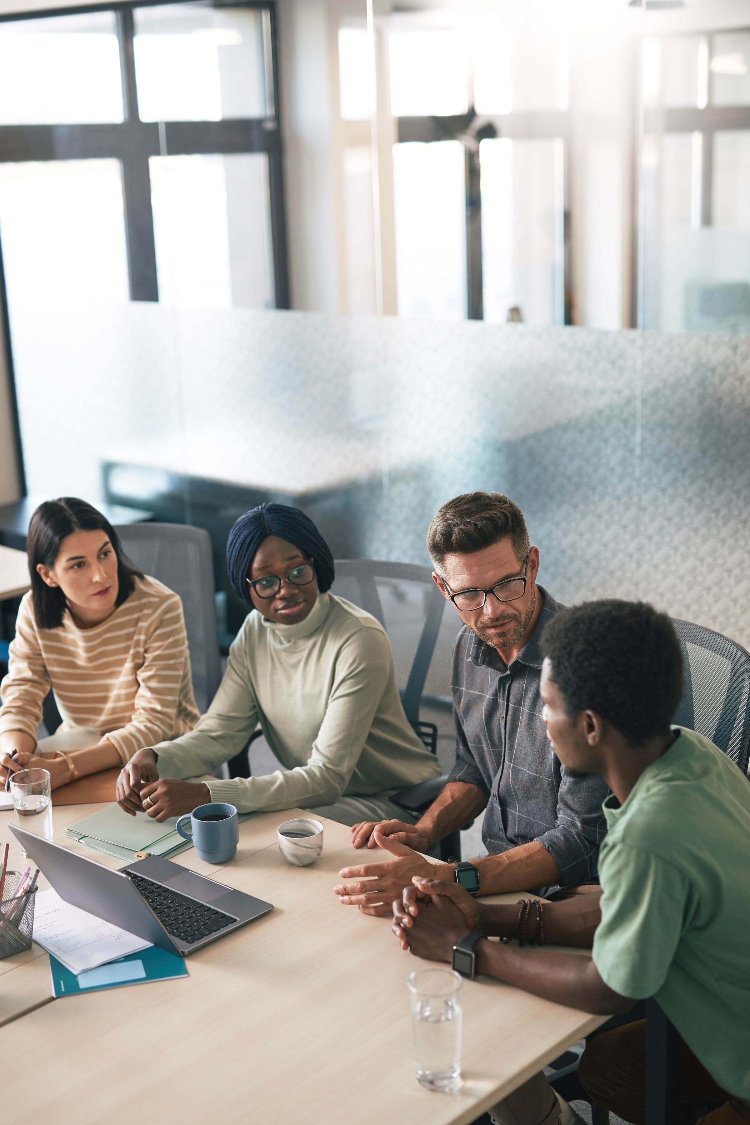 A team of project managers in discussion around a table